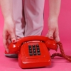 a close up shot of a person holding a telephone
