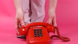 a close up shot of a person holding a telephone