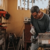 man using bench grinder