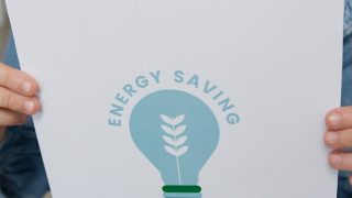 crop photo of a girl holding a slogan on energy saving