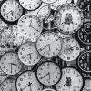 black and white photo of clocks